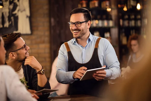 Happy Waiter Using Digital Tablet While Taking Order Couple Pub — 스톡 사진