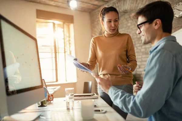 Happy Businesswoman Talking Her Colleague While Analyzing Reports Office — стоковое фото