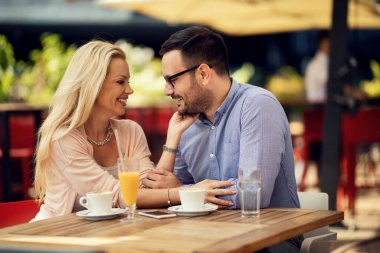 Affectionate couple enjoying in their love while being in a cafe. 