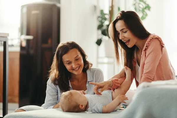 Young Female Couple Playing Baby Son Having Fun Home — Foto de Stock