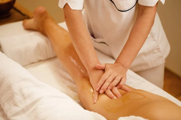 Unrecognizable Woman Having Leg Massage Honey Spa Treatment — 图库照片