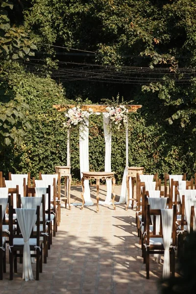 Rustic wedding venue and aisle in a garden before the ceremony.