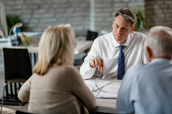 Mid Adult Life Insurance Agent Senior Couple Talking Consultations Office — Fotografia de Stock