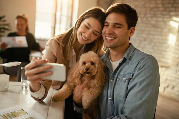 Smiling Business Couple Using Smart Phone While Taking Selfie Poodle — Photo
