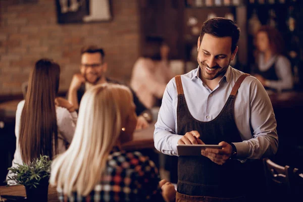 Happy Waiter Using Digital Tablet While Taking Order Female Customer — Stockfoto