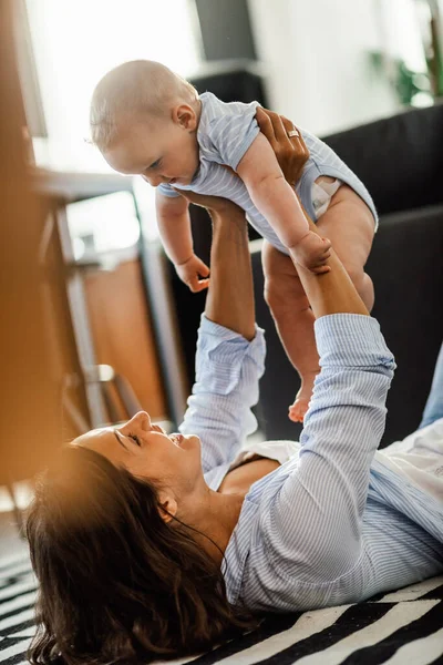 Young Happy Mother Playing Her Baby Having Fun Living Room — Fotografia de Stock