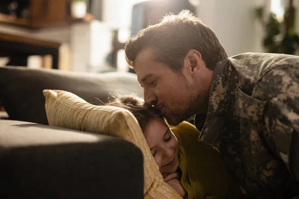 Affectionate Military Father Kissing His Daughter Who Sleeping Sofa Home — Photo