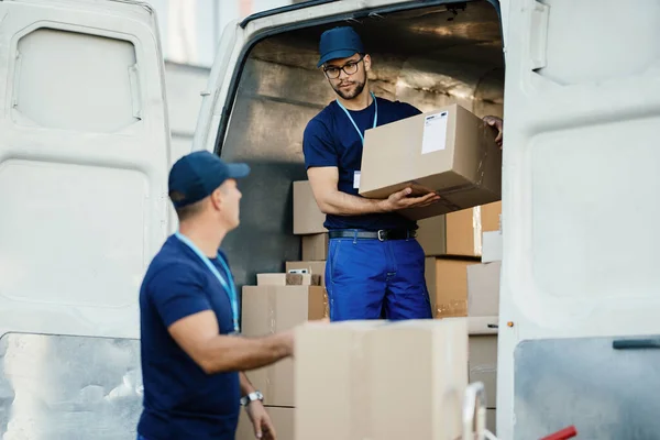 Young Worker Loading Cardboard Boxes Delivery Van Communicating His Colleague — Foto Stock