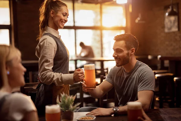 Happy Waitress Serving Male Guest Lager Beer Pub — Foto de Stock