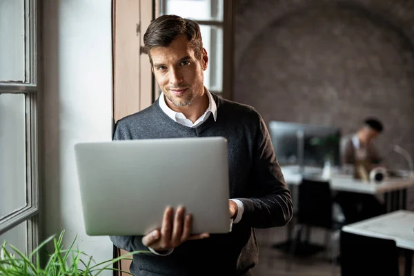 Smiling Freelancer Working Computer While Standing Window Office Looking Camera — Stock Fotó