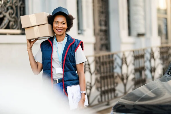 Portrait Happy African American Courier Carrying Packages While Making Delivery — Stockfoto