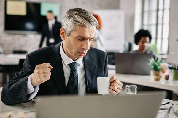 Mid Adult Businessman Celebrating Success While Working Computer Drinking Coffee — Stock Fotó