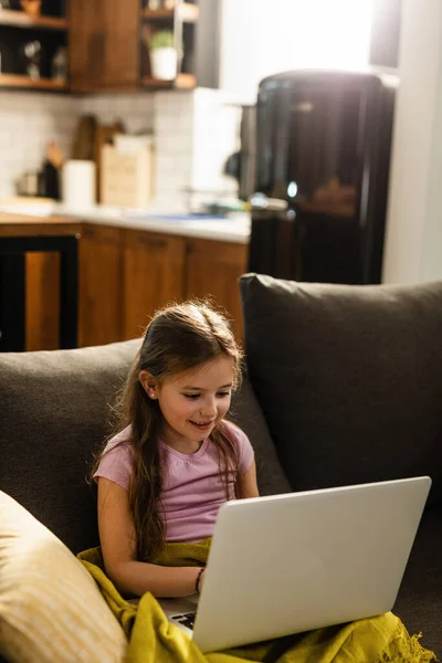 Smiling Little Girl Sitting Sofa Using Laptop Living Room — Stockfoto