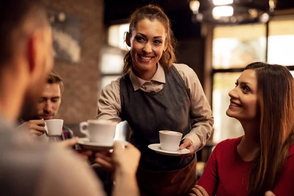 Young Happy Female Waiter Giving Coffee Customers Coffee Shop — Fotografia de Stock