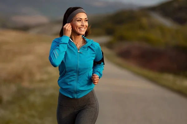 Happy Athletic Woman Listening Music Earphones While Running Nature Morning — Fotografia de Stock