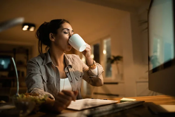 Young Woman Drinking Coffee Eyes Closed While Studying Night Home — Foto de Stock