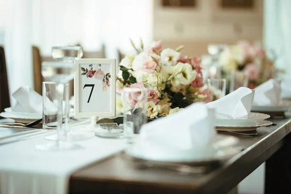 Decorated dining table at wedding reception.