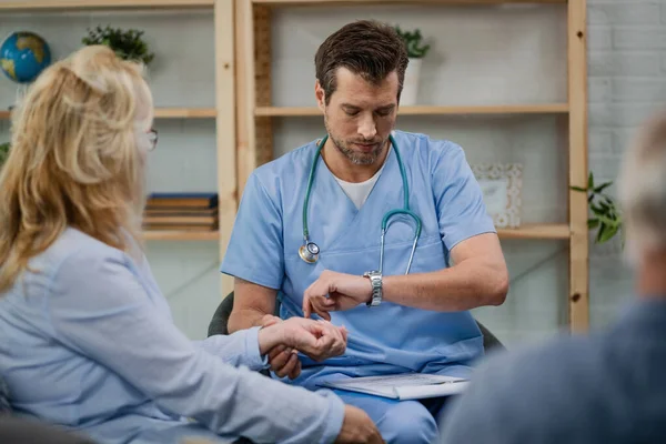 Male Doctor Checking Pulse His Patient Looking Wristwatch While Being — Foto de Stock