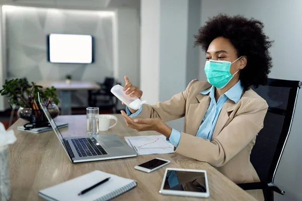 African American Businesswoman Using Hands Sanitizer Wearing Face Mask While — Foto Stock
