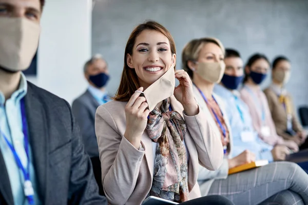 Young Happy Businesswoman Removing Protective Face Mask While Attending Seminar — Foto Stock