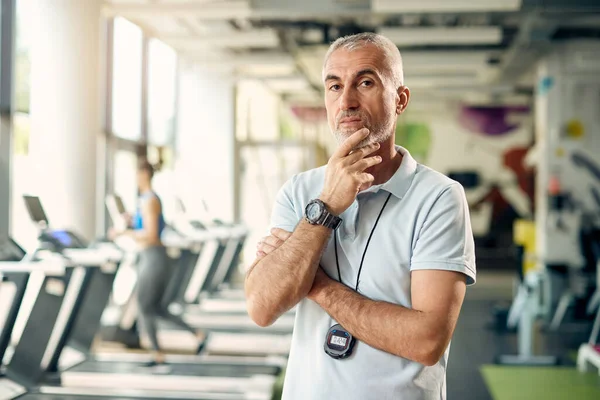 Portrait Mature Personal Trainer Hand His Chin Standing Health Club — Stockfoto