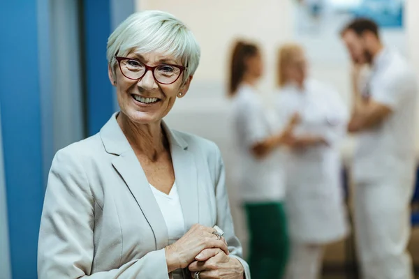 Happy Senior Woman Standing Lobby Medical Clinic Looking Camera — Foto de Stock