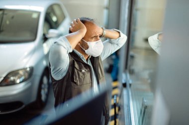 Auto mechanic feeling worried about lack of business at his workshop during coronavirus pandemic. 