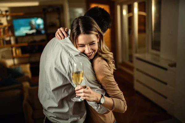 Young Woman Holding Glass Champagne While Embracing Her Boyfriend Evening — стоковое фото