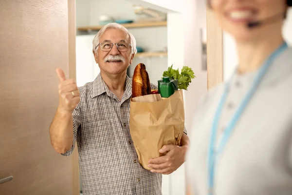 Happy Senior Man Showing Thumbs While Holding Bag Groceries Delivered — Stockfoto