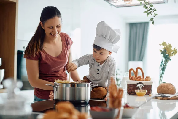 Cute Kid Wearing Chef Hat Cooking His Mother Kitchen — стоковое фото