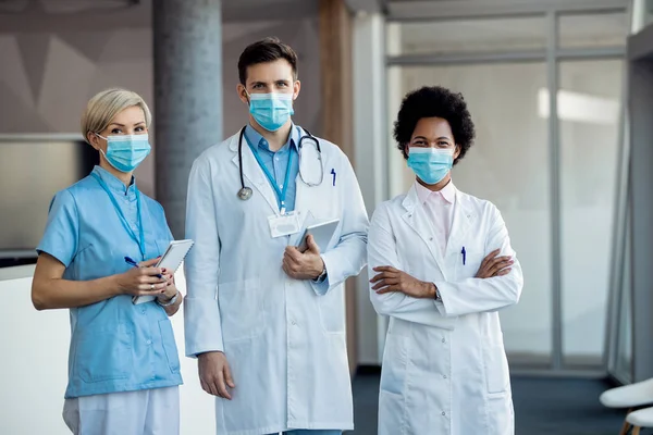 Group Confident Healthcare Workers Wearing Face Masks While Standing Hallway — 스톡 사진