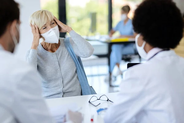 Mature Woman Protective Face Mask Complaining Severe Headache While Talking — 스톡 사진