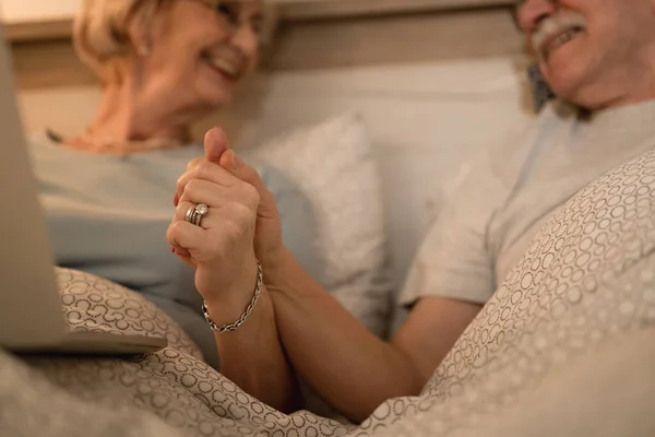 Close Happy Mature Couple Holding Hands While Resting Bedroom Night — 스톡 사진