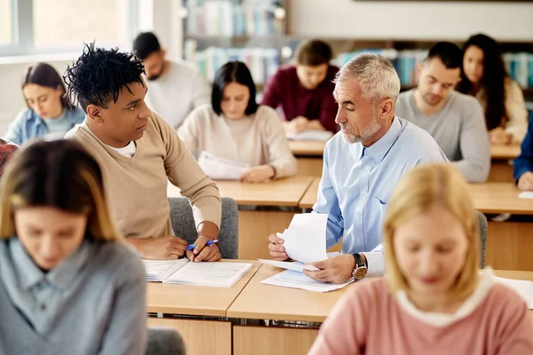 Mature Professor Assisting His African American Student Lecture Class Classroom — Stockfoto