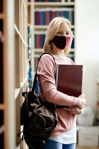Happy University Student Standing Library Wearing Face Mask Due Coronavirus — Stok Foto