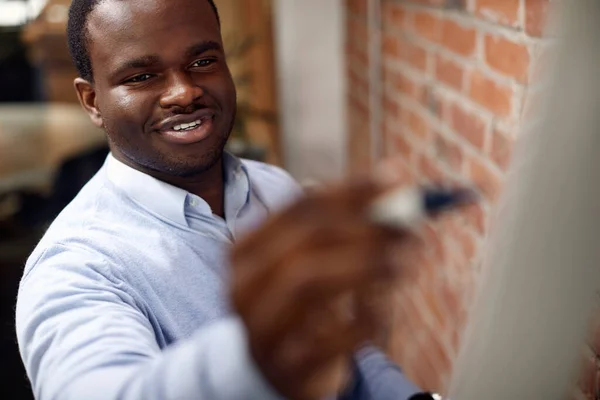 Happy Black Entrepreneur Brainstorming While Giving Business Presentation Writing Whiteboard — Stok fotoğraf