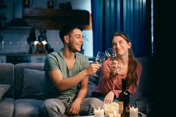 Happy Couple Toasting Wine While Enjoying Romantic Evening Home — стоковое фото