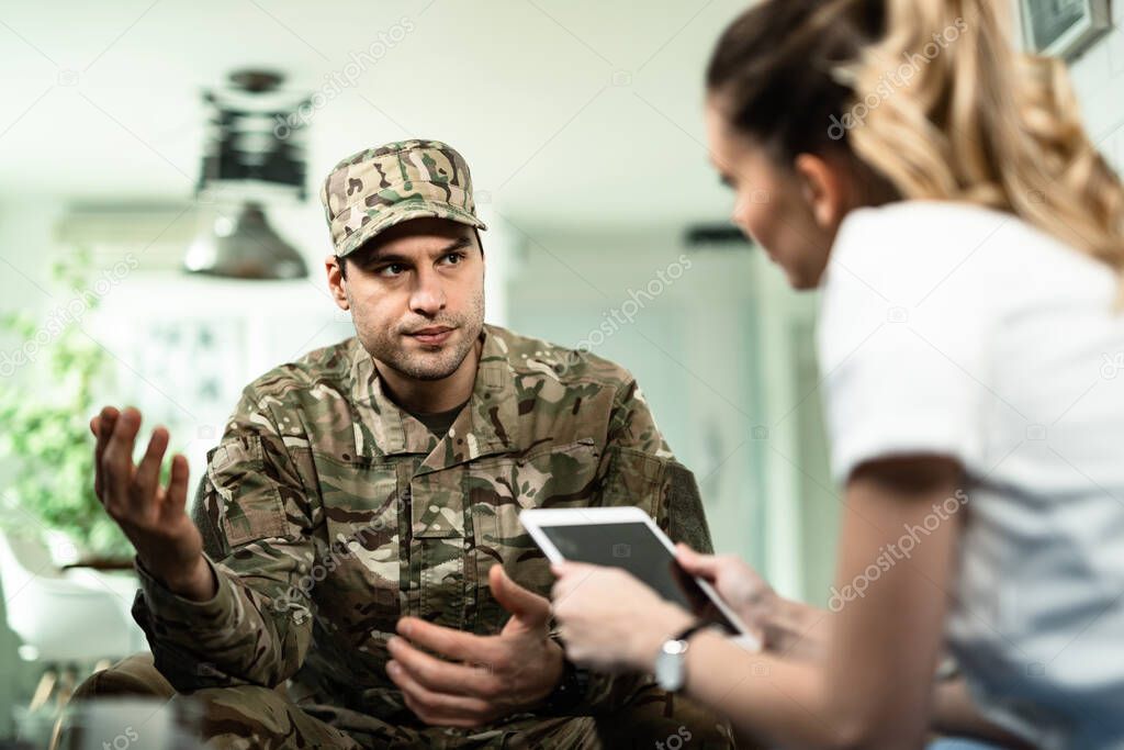 Young veteran talking to healthcare worker about his mental health condition at home. 