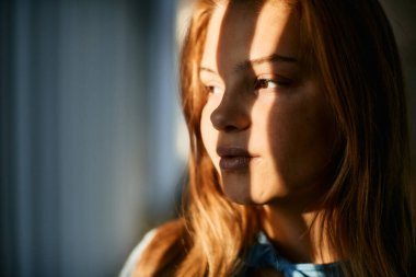 Close-up of thoughtful teenage girl looking way.
