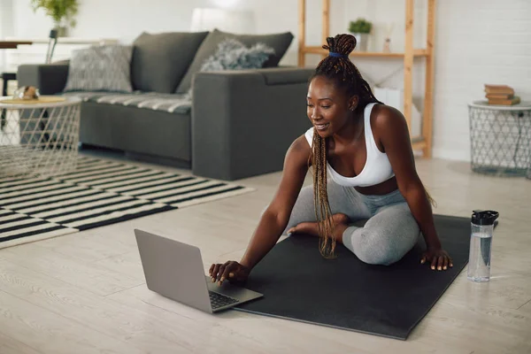 Young African American Female Athlete Using Laptop Home Workout — Photo