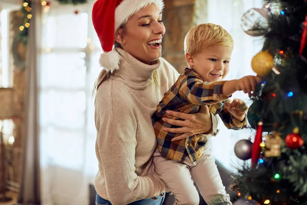 Joyful Mother Her Small Son Decorating Christmas Tree Having Fun — ストック写真