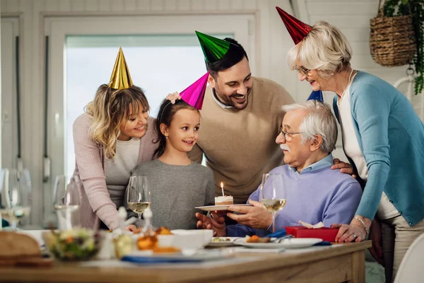 Happy Multi Generation Family Celebrating Senior Man Birthday Surprising Him — стоковое фото
