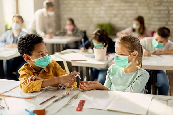 African American Schoolboy Spraying Classmate Hands Disinfectant While Wearing Protective — Foto Stock