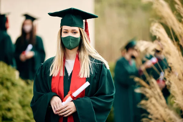 Portrait Happy Female Graduate Protective Face Mask Standing Outdoors Looking — Foto Stock