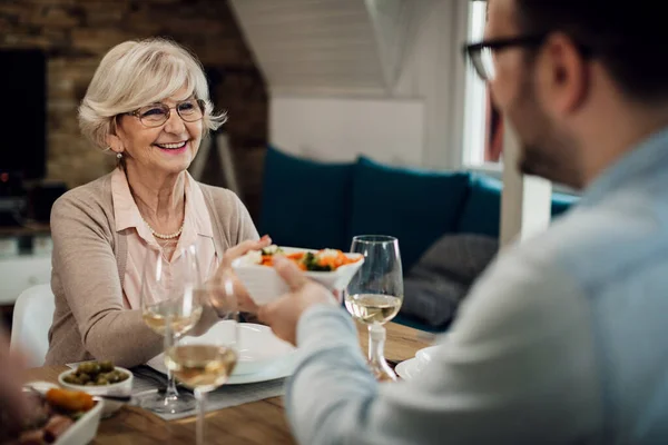 Happy Mature Woman Eating Her Adult Son Passing Him Food — Foto de Stock