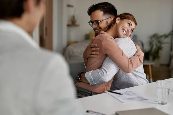 Young Happy Couple Embracing Successful Meeting Real Estate Agent — Stockfoto