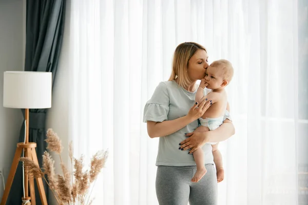 Young Affectionate Mother Enjoying Her Baby Son Kissing Him Home — Stock Photo, Image