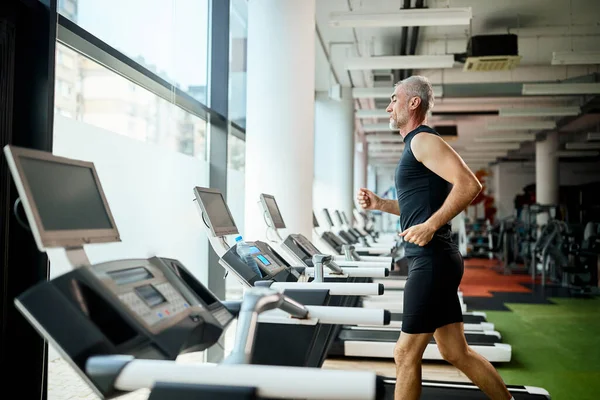 Mature Athlete Runs Treadmill While Exercising Gym — ストック写真