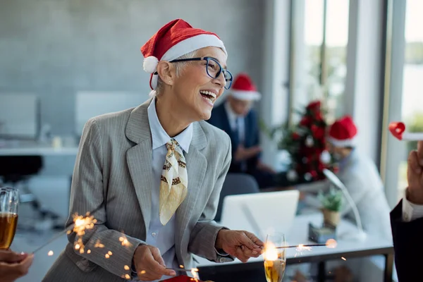 Cheerful Mature Businesswoman Having Fun Sparklers Christmas Party Office — ストック写真