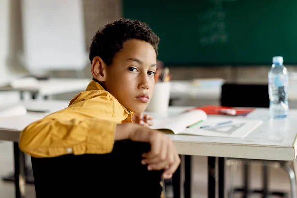 African American Elementary Student Sitting Classroom Looking Camera — Zdjęcie stockowe